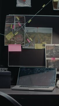 Vertical video: Empty incident room with criminal case investigation, board with clues and evidence. Suspicious research photos and file folders on racks, federal confidential documents in agency