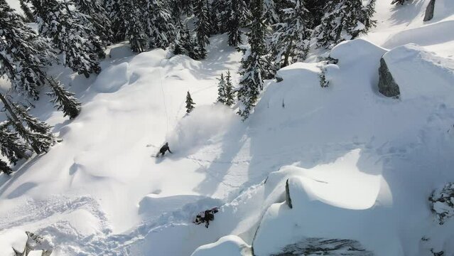 Drone Top View of Snowboarder Riding Backcountry Powder Snow