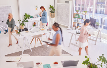 Office diversity, walking and busy women working on woman empowerment advertising research in marketing agency. Coworking group, startup small business and fast moving team planning campaign schedule