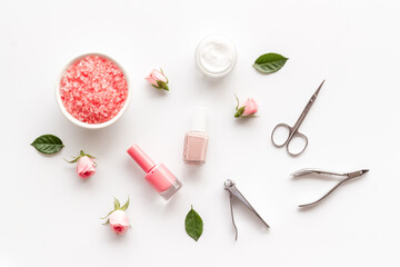 Fototapeta na wymiar Manicure accessories with pink roses flowers. Beauty care salon spa.