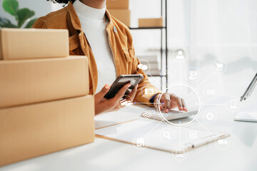 Young entrepreneur women working at home about online business. Business owner women using calculator and smart phone working at home.