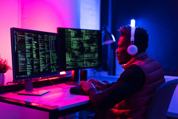 Software developer coding on his computer. Coding and hacking concept.