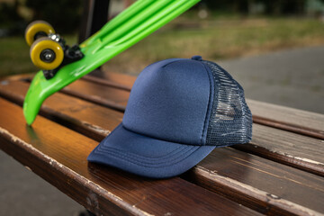 Trucker cap, navy blue, snapback, navy blue mesh. In location on playground. Mock-up for branding