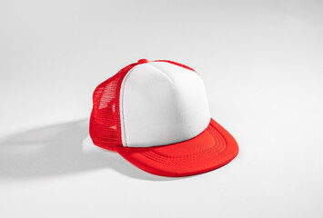 Trucker cap, snapback, red with white front, red mesh, firm. Isolated on white. Mock-up for branding