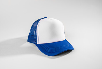 Trucker cap, snapback, blue with white front, blue mesh. Isolated on white. Mock-up for branding