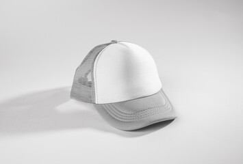 Trucker cap, snapback, grey with white front, grey mesh. Isolated on white. Mock-up for branding