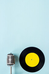 Podcasts or music concept with vinyl records and microphone, top view