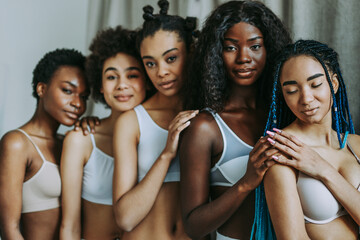 Beautiful black women wearing lingerie underwear posing in studio - Multicultural female models posing in studio on background, concepts about diversity, real authentic people, women's right