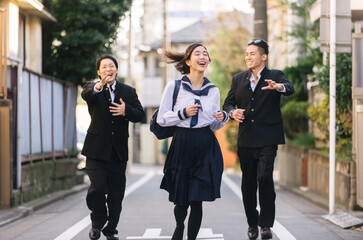 Young japanese students with traditional school college uniforms meeting outdoors in Tokyo - Happy...
