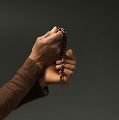 praying to god with hands together Caribbean man with people praying stock photo