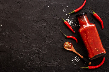 Bottle of spicy sauce tabasco with red hot chili pepper, top view - Powered by Adobe