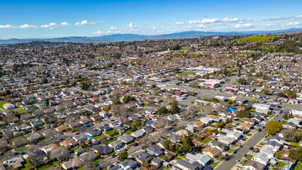 Aerial photos over a community in Vallejo, California with houses, streets, cars and parks on a sunny day in March. - obrazy, fototapety, plakaty