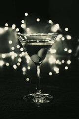 A glass of dirty martini without olives, with blurred background light and bokeh