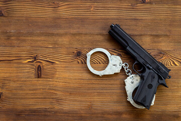 Hand gun weapon with handcuffs. Arrest of a criminal concept