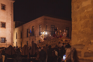 Holy Week procession walking down the street at night