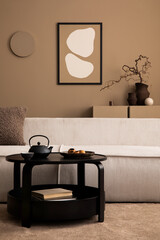 Creative composition of living room interior with mock up poster frame, modular sofa, round coffee table, pitcher, vase with branch, brown sideboard and personal accessories. Home decor. Template.