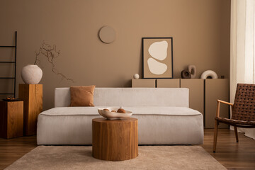 Interior design of aesthetic living room interior with mock up poster frame, round coffee table, modular sofa, brown rug, wooden stand, vase with branch and personal accessories. Home decor. Template.