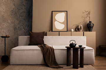 Interior design of creative living room interior with mock up poster frame, modular sofa, wooden coffee table, brown plaid, pillow, vase with branch and personal accessories. Home decor. Template.