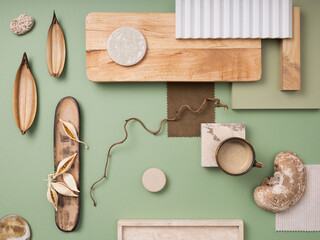 Fototapeta na wymiar Stylish flat lay composition in green and brown color palette with textile and paint samples, lamella panels and tiles. Architect and interior designer moodboard. Top view. Copy space.