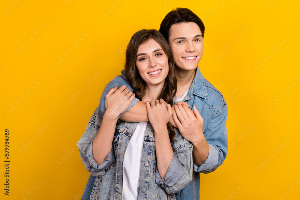 Sticker Photo of two attractive idyllic young people cuddle toothy smile isolated on yellow color background