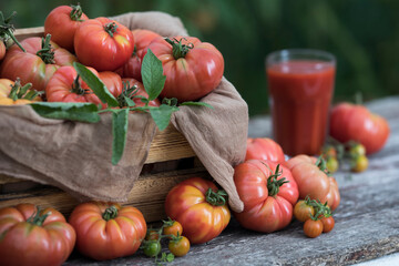 Fresh tomato juice, on a wooden background