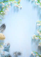 Easter eggs and Spring flower border on blue background; white spring blossom border; copy space
