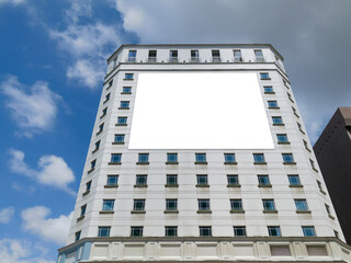 Blank advertising horizontal banner poster mockup on modern tall building facade exterior. Super...