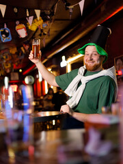 Men with beer celebrating St Patrick's day in pub, closeup