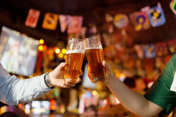 People drinking beer on pub and bar background. St. Patrick's Day