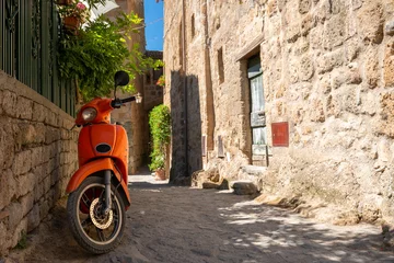 Gordijnen Scooter orange scooter parked in the beautiful mediterranean street  © Anselm