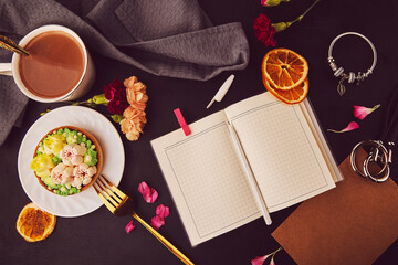 Aesthetic floral french tart among flowers, coffee cup, mock up of notepad, accessories flat lay. Desserts using the trend Dreamy Escapism. Pink floral cake