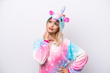 Obraz na płótnie Canvas Young Russian woman with unicorn pajamas isolated on white background thinking an idea