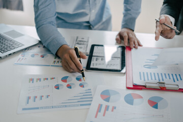 Business people are deeply examining financial reports for investment returns or investment risk analysis.