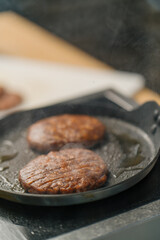 Burger patties burger meat on a hot pan delicious burgers in a professional kitchen