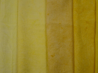 Samples of cotton fabric with gradient in yellow tones, background.  Natural dyeing for fabrics, DIY
