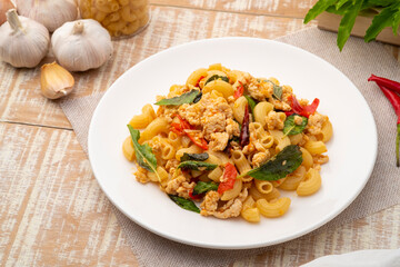 Stir-fried elbow macaroni with ground chicken in white plate,Pad Kra Pao,Thai fusion food