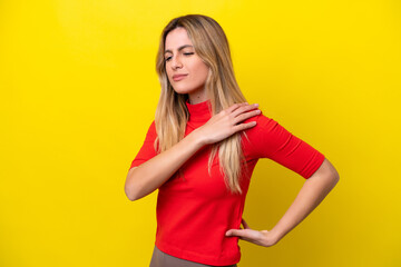 Young Uruguayan woman isolated on yellow background suffering from pain in shoulder for having made an effort