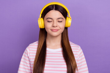 Photo of adorable dreamy girl dressed striped t-shirt closed eyes enjoying songs isolated purple color background