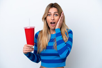 Young Uruguayan woman drinking soda isolated on white background with surprise and shocked facial expression