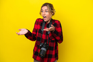 Uruguayan photographer woman isolated on yellow background with surprise facial expression