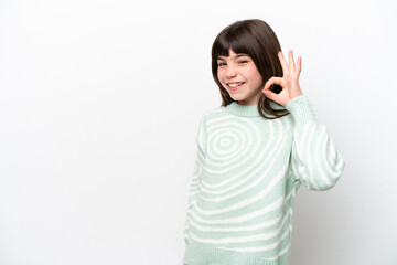 Little caucasian girl isolated on white background showing ok sign with fingers
