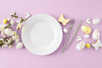 Easter decoration concept. Top view composition of empty plate cutlery fork knife colorful easter...