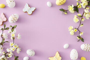 Easter celebration idea. Top view photo of white yellow easter eggs butterfly shaped cookies and spring blossom flowers on pastel lilac background with empty space in the middle