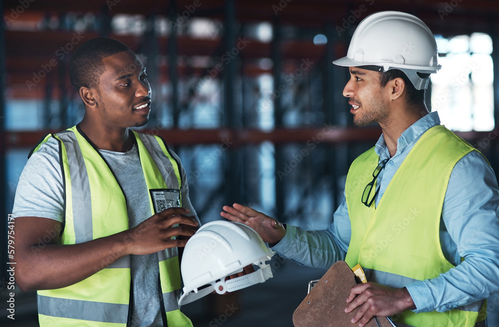 Poster i dont want any problems. shot of two young contractors standing in the warehouse together and havin