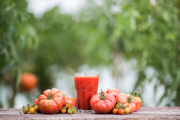 Fresh red tomato juice, on a wooden background
