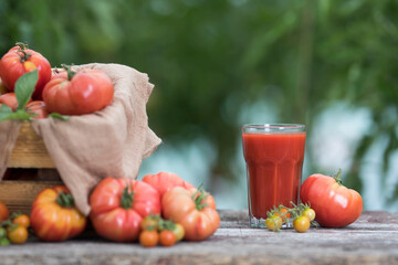 Fresh red tomato juice, on a wooden background