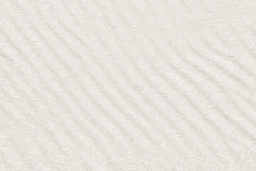 Fototapeta na wymiar Full frame shot of stripes made by water waves. Sand stripes texture background.