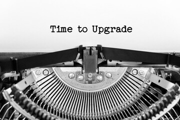 Time to Upgrade phrase closeup being typing and centered on a sheet of paper on old vintage typewriter mechanical - obrazy, fototapety, plakaty