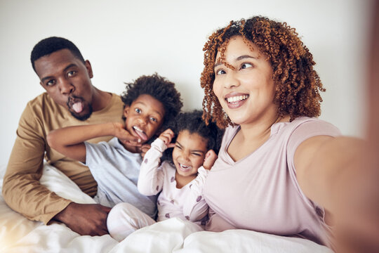 Black family, selfie and funny face portrait in home bedroom, smile and having fun together. Interracial, comic and father, mother and children taking pictures for happy memory and social media.