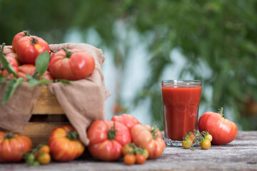 Fresh red tomato juice, on a wooden background